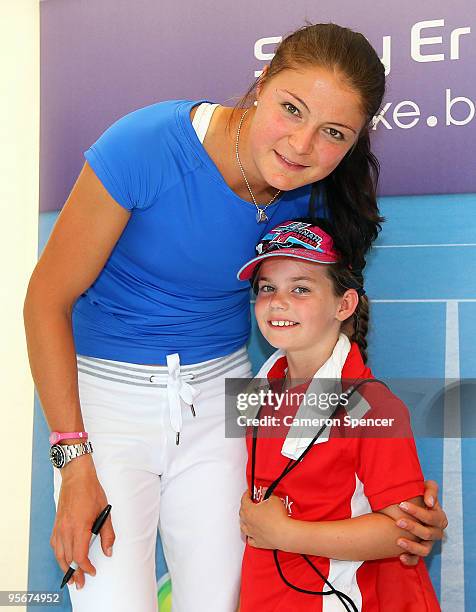 Dinara Safina of Russia poses with a young fan at a signing session during day one of the 2010 Medibank International at Sydney Olympic Park Sports...