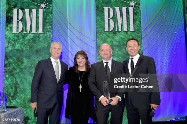 Trevor Morris accepts award from BMI Vice President, Creative - Film, TV & Visual Media Doreen Ringer Ross, Executive Vice President of Creative &...