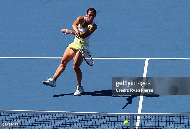 Francesca Schiavone of Italy plays a smash in her first round match against Elana Dementieva of Russia during day one of the 2010 Medibank...