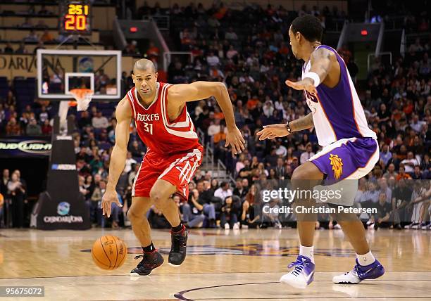 Shane Battier of the Houston Rockets drives the ball past Channing Frye of the Phoenix Suns during the NBA game at US Airways Center on January 6,...