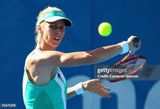 Elena Dementieva of Russia plays a backhand in her first round match against Francesca Schiavone of Italy during day one of the 2010 Medibank...