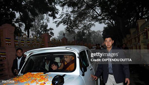 Tibetan spiritual leader The Dalai Lama waves from his vehicle to the followers on his way to a special prayer session at The Mahabodhi Temple in...