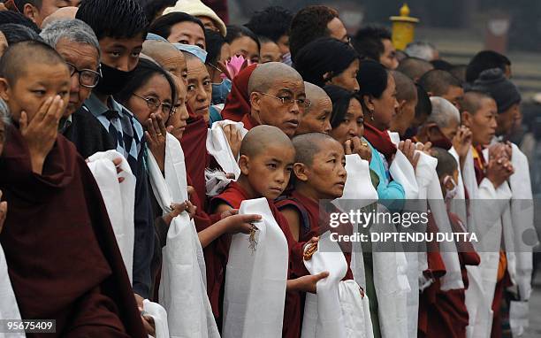 Devotees wait to catch a glimpse of Tibetan spiritual leader The Dalai Lama on his way to a special prayer session at The Mahabodhi Temple in...