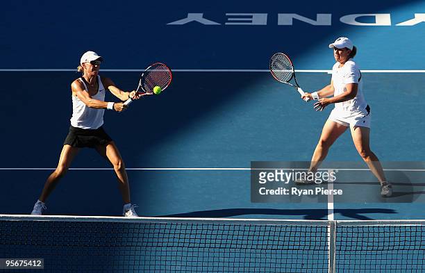 Rennae Stubbs of Australia plays a volley with Lisa Raymond if the USA in their first round match against Casey Dellacqua of Australia and Aravane...