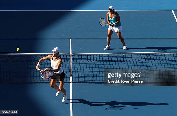Rennae Stubbs of Australia plays a volley with Lisa Raymond of the USA in their first round match against Casey Dellacqua of Australia and Aravane...