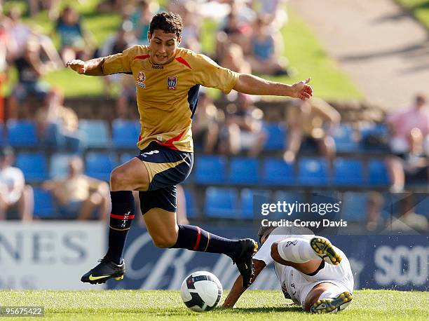 Adam D'Apuzzo of the Jets is challenged by Carlos Hernandez of the Victory during the round 22 A-League match between the Newcastle Jets and...