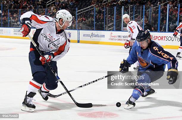 Brendan Morrison of the Washington Capitals battles for the puck against Todd White of the Atlanta Thrashers at Philips Arena on January 9, 2010 in...