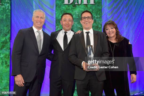 Mac Quayle accepts award from BMI Vice President, Creative - Film, TV & Visual Media Doreen Ringer Ross, Executive Vice President of Creative &...