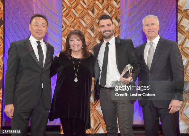 Ryan Elder accepts award from BMI Vice President, Creative - Film, TV & Visual Media Doreen Ringer Ross, Executive Vice President of Creative &...