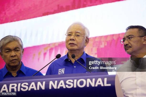 Najib Razak, Malaysia's outgoing prime minister, center, speaks as Ahmad Zahid Hamidi, outgoing deputy prime minister, left, and Hishammuddin...