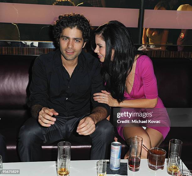 Actor Adrian Grenier and model Jayde Nicole mingle at the amfAR Cocktail Party & PokerStars Red Carpet And Party at Aura Nightclub on January 9, 2010...