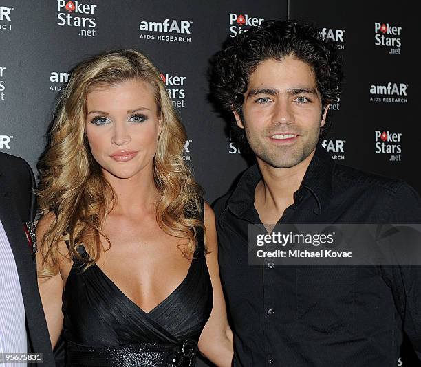 Personality Joanna Krupa and actor Adrian Grenier arrive at the amfAR Cocktail Party & PokerStars Red Carpet And Party at Aura Nightclub on January...