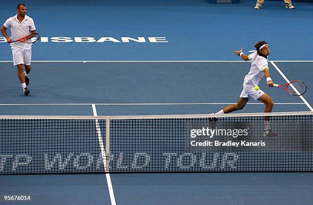 Jeremy Chardy of France plays a backhand volley playing with Marcus Gicquel of France in his final against Lucas Dlouhy of the Czech Republic and...