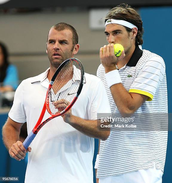 Marcus Gicquel of France and Jeremy Chardy of Francediscuss tactics in the men's doubles final against Lucas Dlouhy of the Czech Republic and Leander...