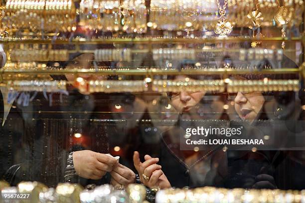 Muslim women check bracelets at a goldsmith's shop in the Gold Market at the historic bazaar of Old Damascus on January 6, 2010. Syrians have not...