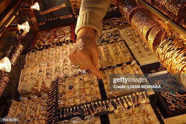 Syrian woman tries rings at a goldsmith's shop in the Gold Market at the historic bazaar of Old Damascus on January 6, 2010. Syrians have not stopped...