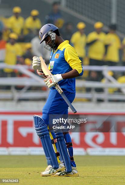 Sri Lankan cricketer Thissara Perera leaves the ground after losing his wicket during the Tri-Nation tournament One Day International cricket match...