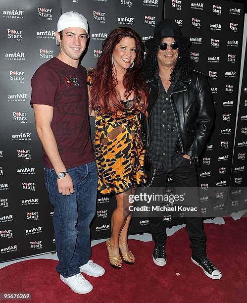 Poker champion Joe Cada, Perla Hudson, and musician Slash attend the amfAR Cocktail Party & PokerStars Red Carpet And Party at Aura Nightclub on...