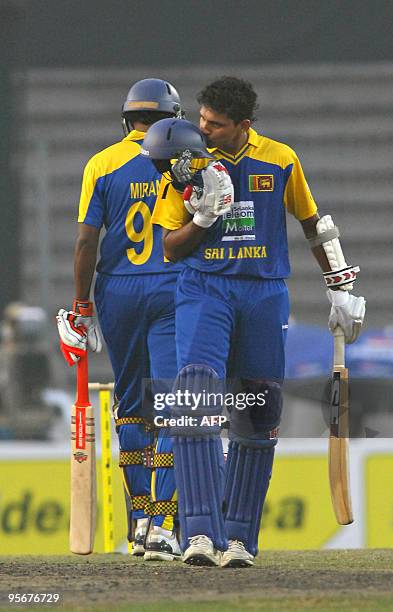 Sri Lankan cricketer Suraj Randiv kisses his helmet after scoring half a century during the Tri-Nation tournament One Day International cricket match...