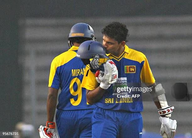 Sri Lankan cricketer Suraj Randiv kisses his helmet after scoring a half century during the Tri-Nation tournament One Day International cricket match...