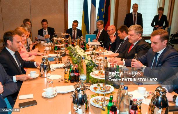 German Chancellor Angela Merkel , French President Emmanuel Macron and Ukrainian President Petro Poroshenko meet for talks on the conflict in...