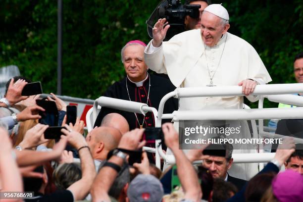 Pope Francis waves to the crowd as he arrives at the Mary Theotokos Shrine during a pastoral visit in Loppiano, on May 10, 2018 near Grosseto,...