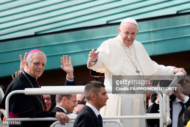 Pope Francis, flanked by Mario Meini, bishop of Fiesole, greets the crowd as he arrives at the Mary Theotokos Shrine during a pastoral visit in...