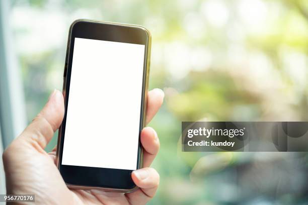 hand holding mobile with empty screen for background. mobile mock up for advertising. - hand mobile stock-fotos und bilder