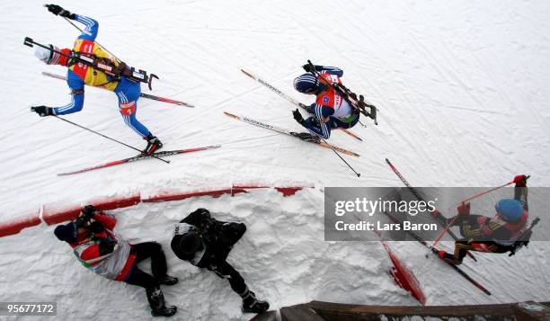 Evgeny Ustyugov of Russia competes infront of Tim Burke of USA and Michael Greis of Germany during the Men's 15 km mass start in the e.on Ruhrgas IBU...