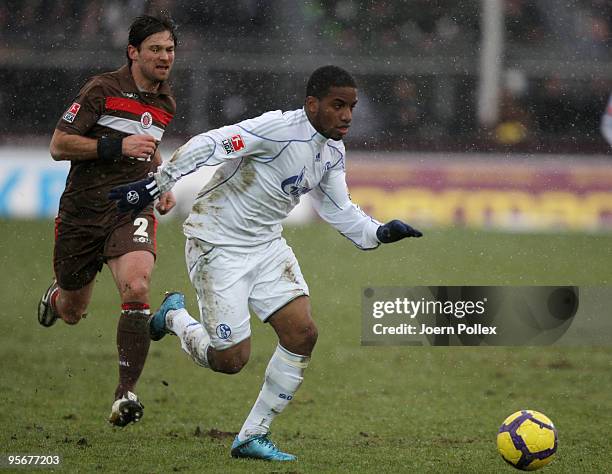 Florian Lechner of St. Pauli and Jefferson Farfan of Schalke battle for the ball during the friendly match between FC St. Pauli and FC Schalke 04 at...