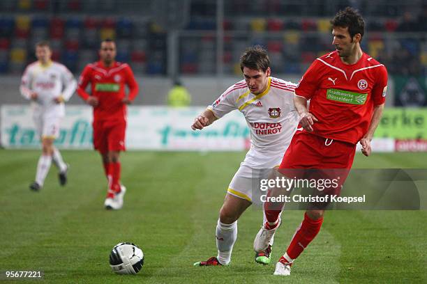 Patrick Helmes of Bayer Leverkusen tackles Jens Langeneke of Duesseldorf during the Wintercup match between Fortuna Duesseldorf and Bayer 04...