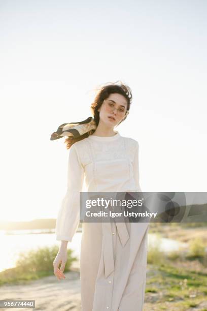 young woman posing outdoors - skirt blowing stock pictures, royalty-free photos & images