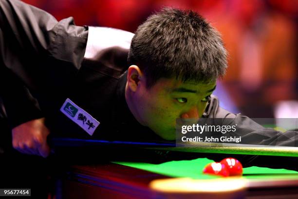 Ding Junhui of China lines up a shot during his match against Mark Selby of England in the PokerStars.com Masters Snooker tournament at Wembley Arena...