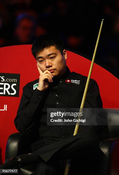 Ding Junhui of China looks dejected during his match against Mark Selby of England in the PokerStars.com Masters Snooker tournament at Wembley Arena...