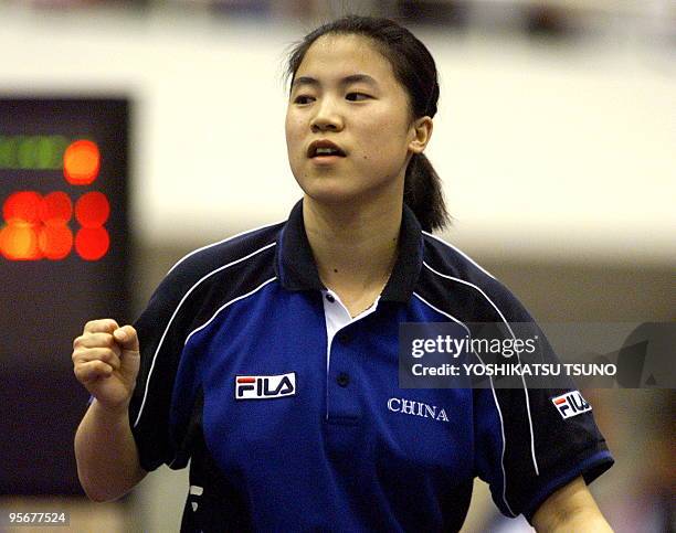 Wang Nan of China clinches her fists as she defeated North Korea's Tu Jong-Sil during the women's team final event of table tennis of the 13th Asian...