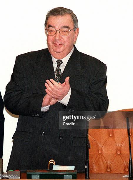 Russian Prime Minister Yevgeny Primakov applauds at the end of the Cabinet meeting in Moscow 10 December. His government launched final deliberations...