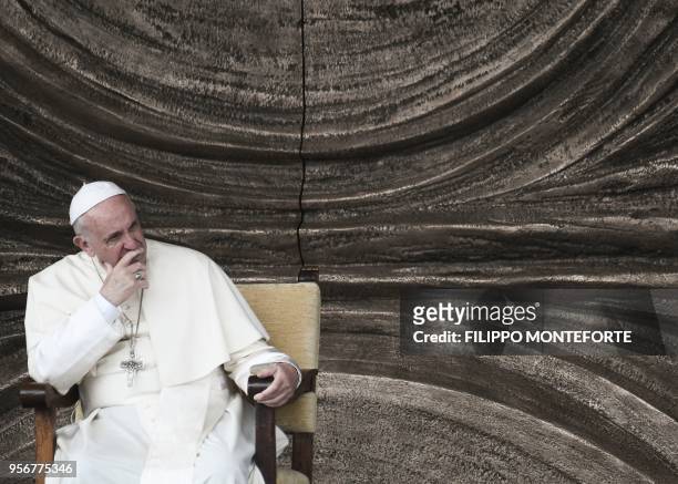 Pope Francis sits on the parvis of the Mary Theotokos Shrine during a pastoral visit in Loppiano, on May 10, 2018 near Grosseto, Tuscany.