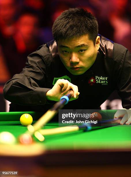 Ding Junhui of China lines up a shot during his game against Mark Selby of England in the PokerStars.com Masters Snooker tournament at Wembley Arena...