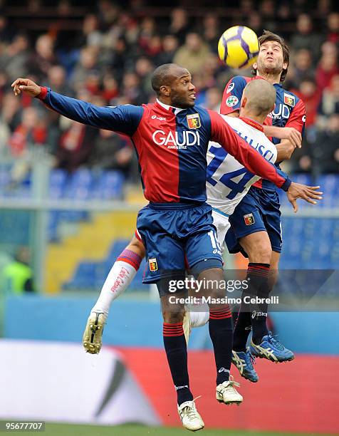 David Suazo and Giuseppe Sculli of Genoa CFC go up for the ball against Giuseppe Bellusci of Catania Calcio during the Serie A match between Genoa...