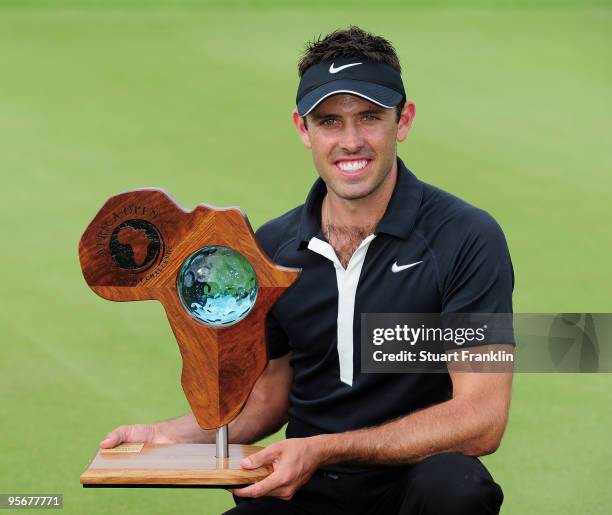 Charl Schwartzel of South Africa holds the winners trophy after the final round of the Africa Open at the East London Golf Club on January 10, 2010...