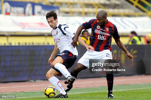 Marcelo Danubio Zalayeta of Bologna competes for the ball with Davide Astori of Cagliari during the Serie A match between Bologna and Cagliari at...