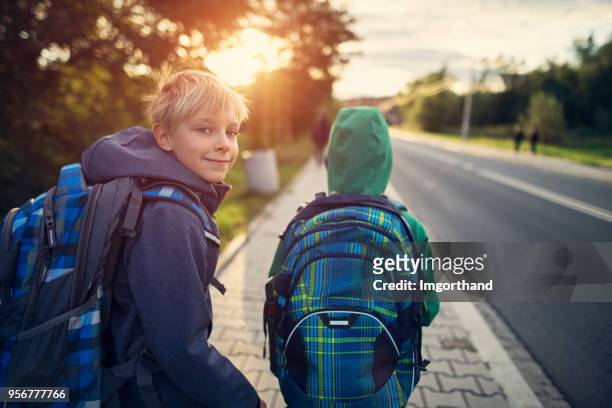 school boys walking to school - education stock pictures, royalty-free photos & images