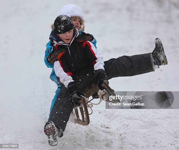 Cousins Serefina Tschoepe and Max Tschoepe catch air as they sled down a hill in Zehlendorf district on January 10, 2010 in Berlin, Germany. A...