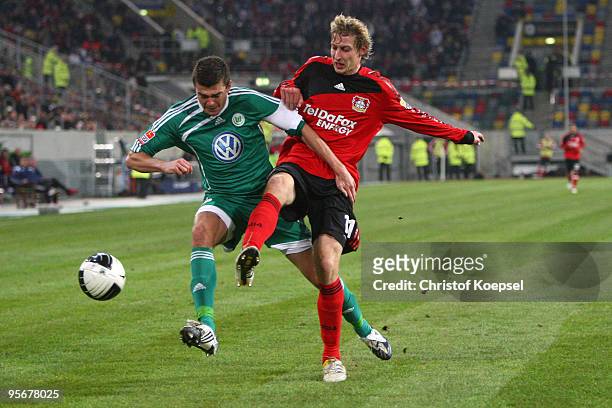Stefan Kiessling of Bayer Leverkusen tackles Josué of Wolfsburg during the Wintercup third place match between Bayer Leverkusen and VfL Wolfsburg at...