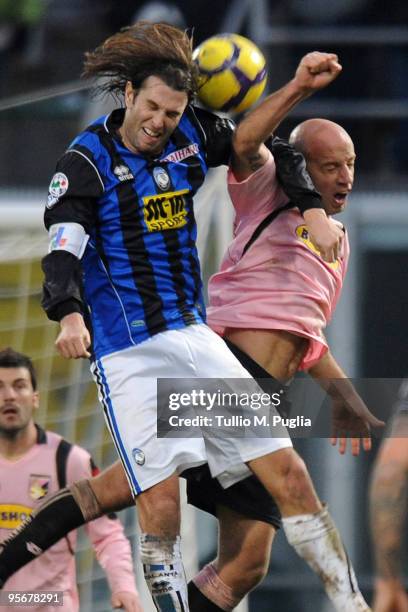 Cristiano Doni of Atalanta and Giulio Migliaccio of Palermo compete for a header during the Serie A match between US Citta di Palermo and Atalanta BC...