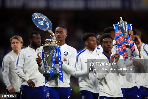Chelsea youth teams parade their U18 Premier League and FA Youth Cup trophies at half time during the Premier League match between Chelsea and...