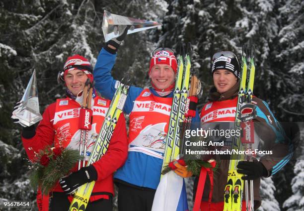 2nd Petter Northug of Norway, 1st Lukas Bauer of Czech Republic and 3rd Dario Cologna of Switzerland celebrate their success during the final climb...