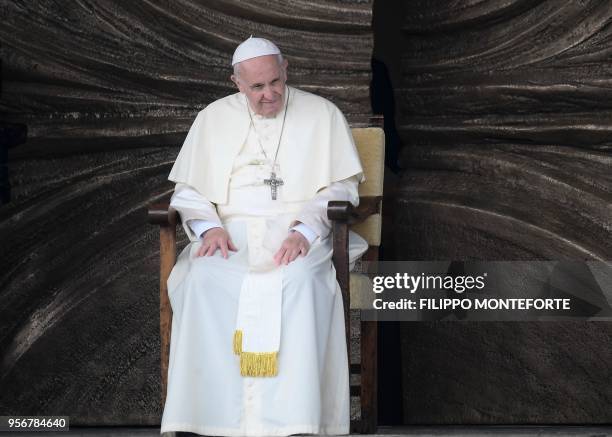 Pope Francis sits on the parvis of the Mary Theotokos Shrine during a pastoral visit in Loppiano, on May 10, 2018 near Grosseto, Tuscany.