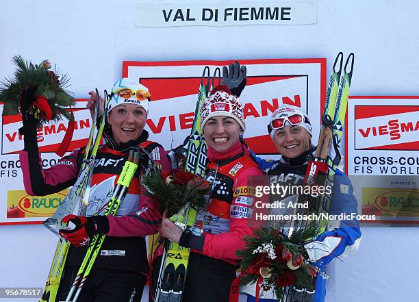 2nd Petra Majdic of Slovenia, 1st Justyna Kowalczyk of Poland and 3rd Arianna Follis of Italy celebrate their success during the final climb women...