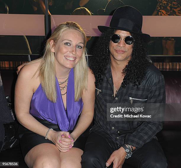 Tori Coxon and musician Slash attend the amfAR Cocktail Party & PokerStars Red Carpet And Party at Aura Nightclub on January 9, 2010 in Nassau,...